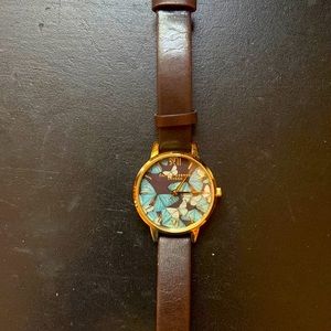 Olivia Burton gold butterfly face watch with dark brown leather strap